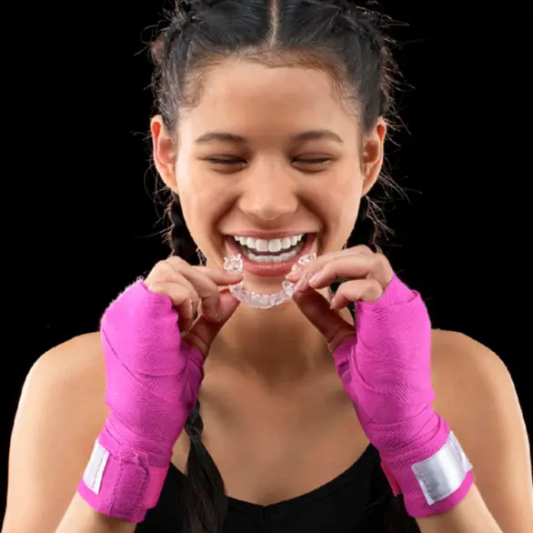 A girl tries to wear a mouth guard