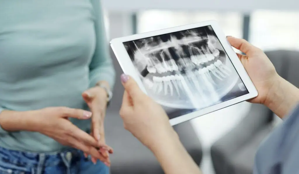 woman holding a dental x-ray