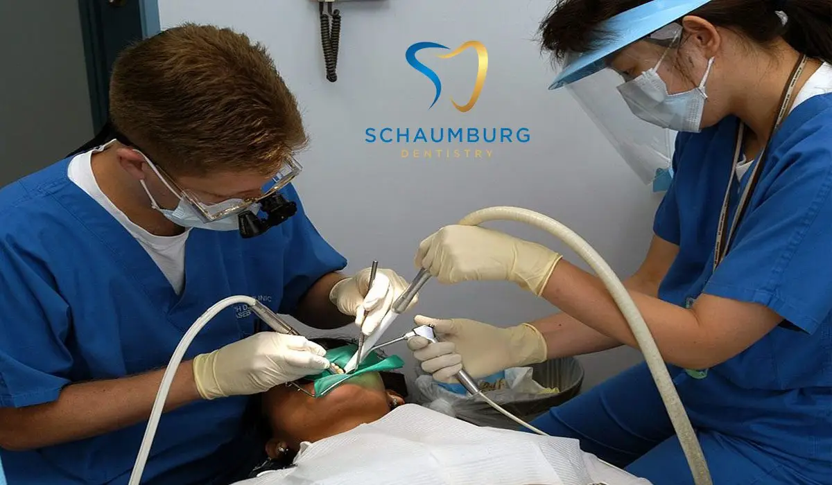 Two dentists extracting teeth from the patient.