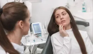 Patient discussing dental emergency with a dentist during same-day dental care appointment.